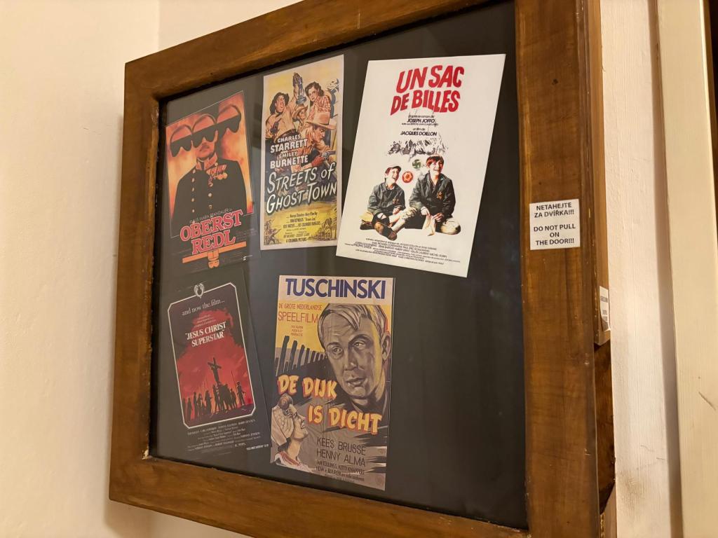 5 movie posters displayed in a wooden display case, some in foreign languages