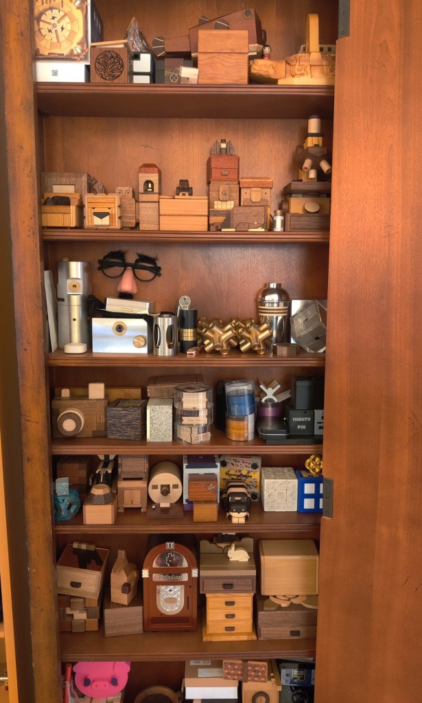 wooden shelf full of mechanical puzzles