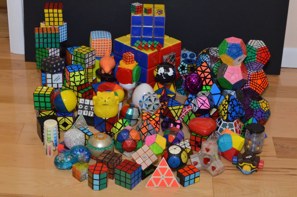 dozens of different styles of colorful rubiks cubes