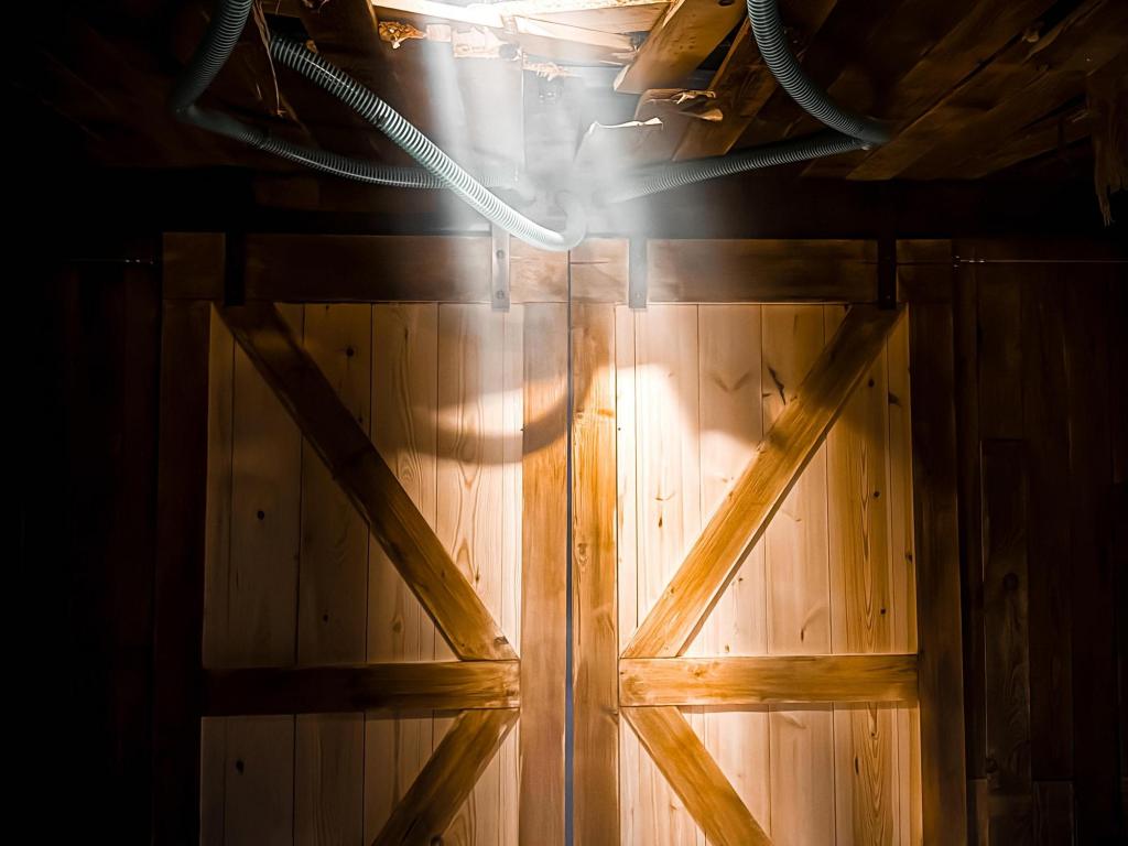 Image of a wooden barn door with light streaming in from above.