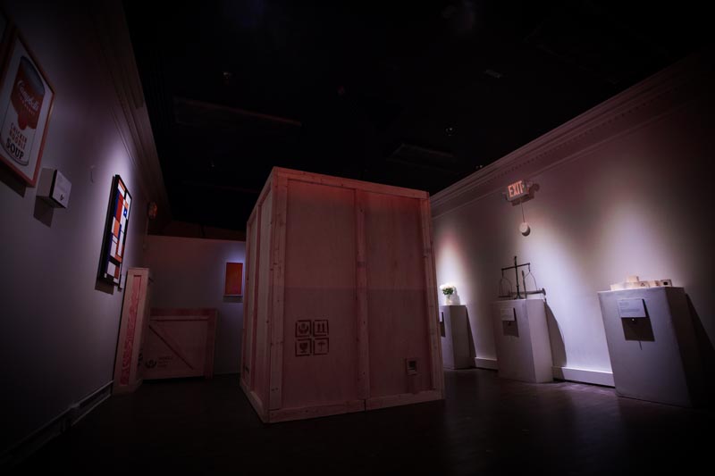 art gallery with large wooden crate in the center