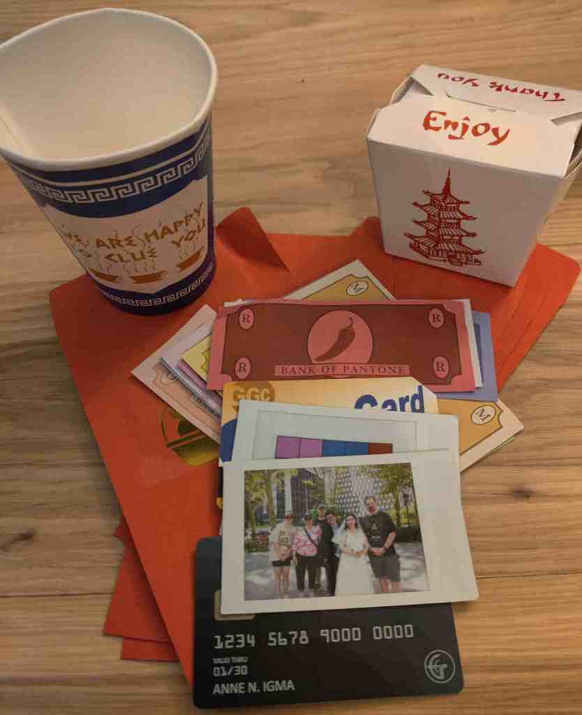 a display of puzzle components from GGC including a coffee cup, Chinese food takeout box, fake money, and a photo of a team