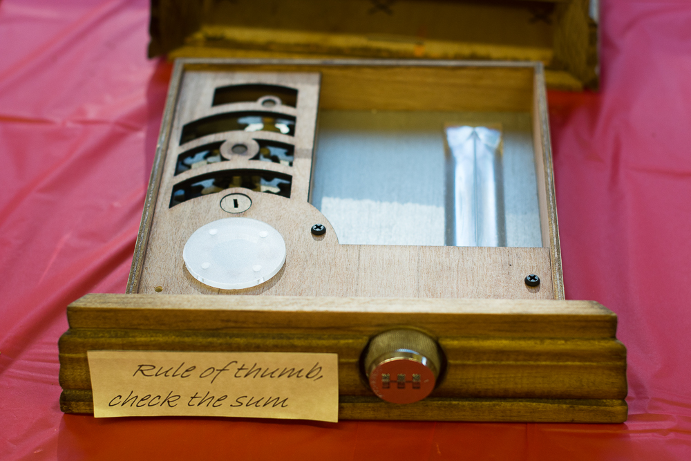 wooden puzzle drawer with sign that says "rule of thumb check the sum"