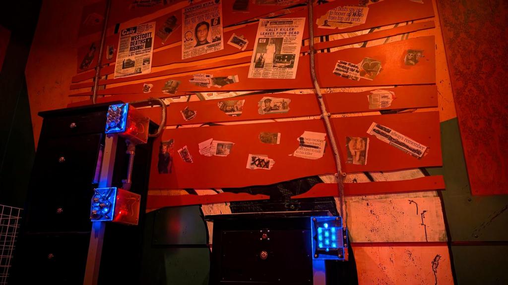 Boards with various macabre newspaper clippings above some cabinets